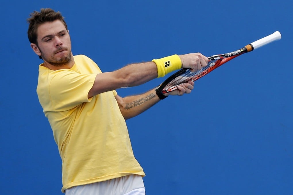 Defending Australian Open champion Stan Wawrinka of Switzerland warms up during a training session at Melbourne Park. Photos: EPA