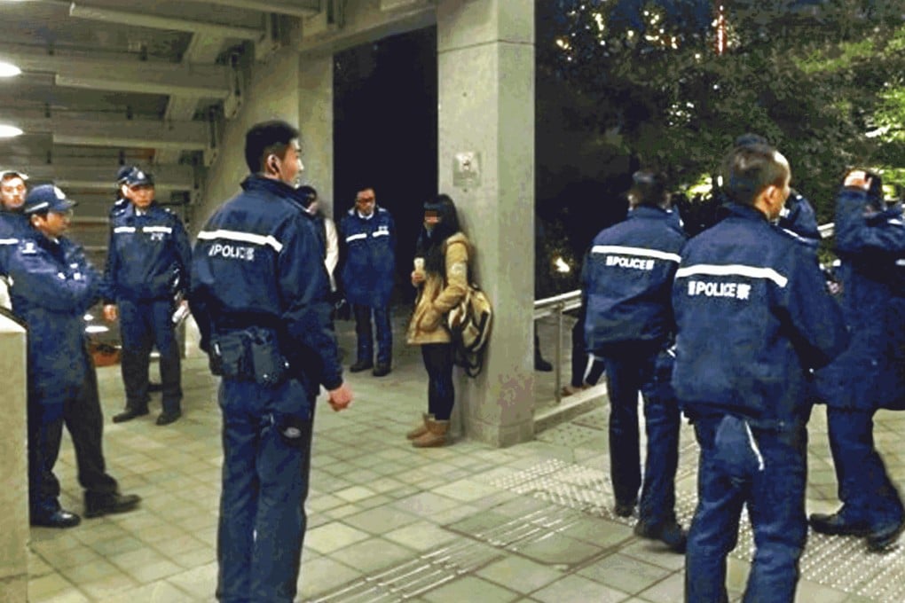 Police officers surround the girl in Admiralty.Photo: SCMP Pictures