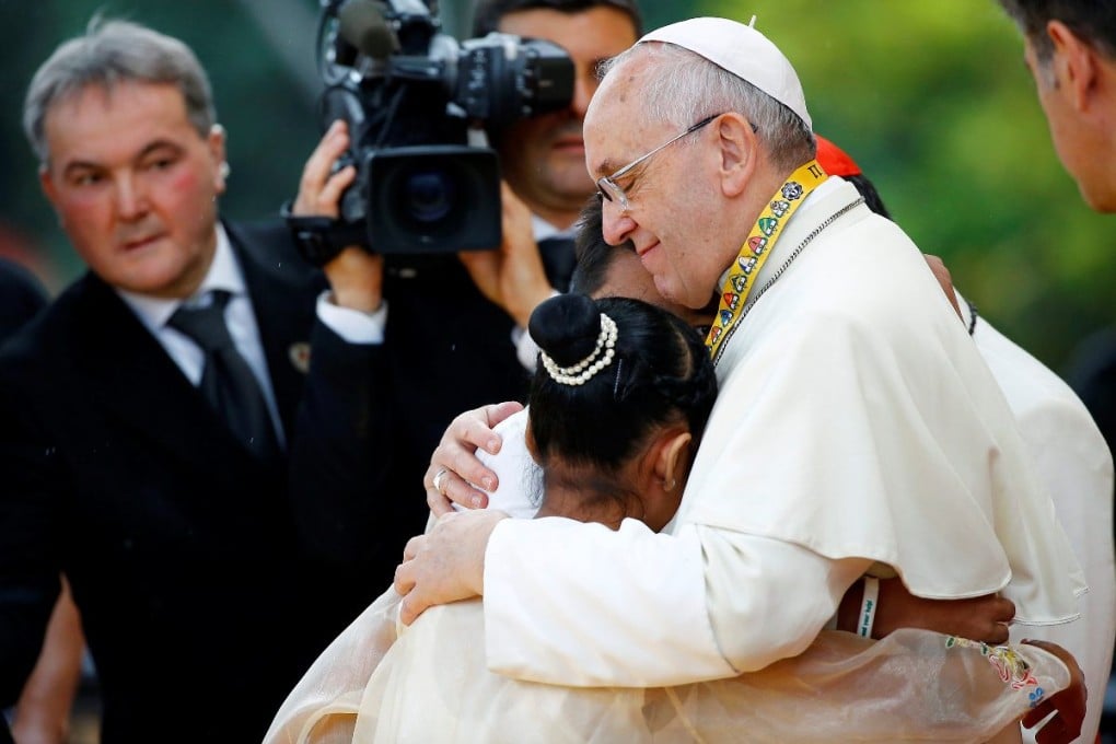 Pope Francis hugs a weeping Glyzelle Palomar. Photo: Reuters