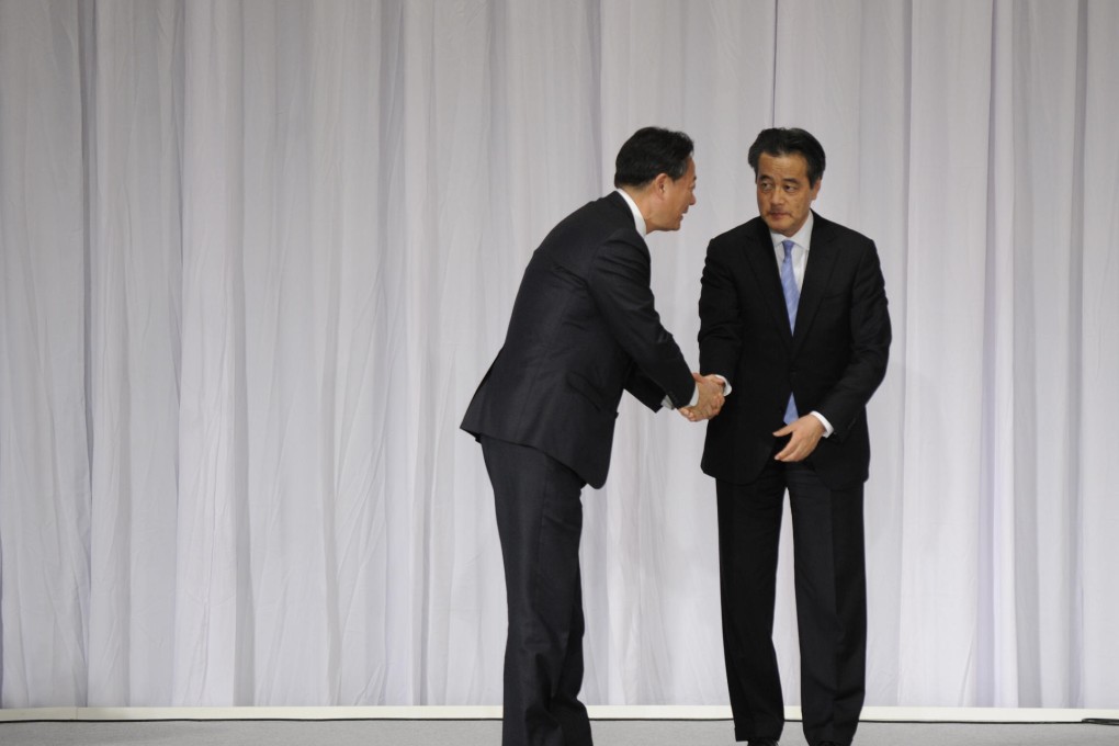 Katsuya Okada (right) greets Banri Kaieda.Photo: Xinhua