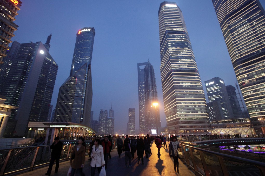 Shanghai's Pudong financial district at night. China's property sector is seen weighing on the economy in 2015 as GDP growth posted its slowest rise in 24 years. Photo: Bloomberg