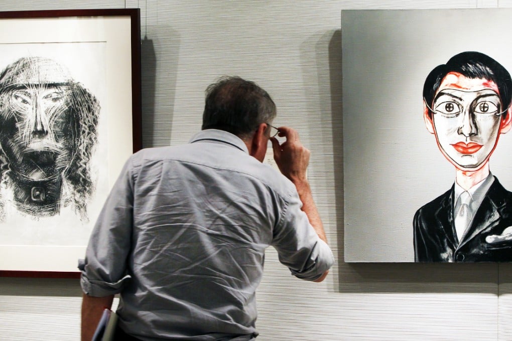 A client browses for artwork at a Christie's Hong Kong exhibition. Hong Kong and other areas in Greater China were key to the auction house's record sales last year. Photo: David Wong