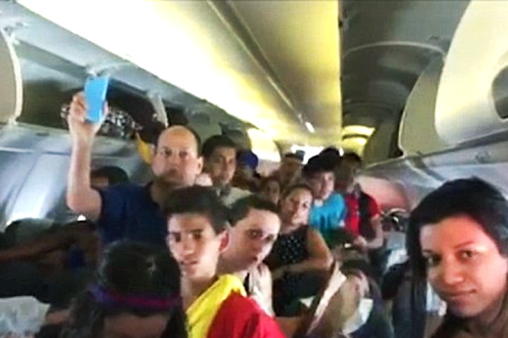 Globo television network broadcast videos shot inside the plane that show overheated passengers fanning themselves before deciding to open the emergency exits.