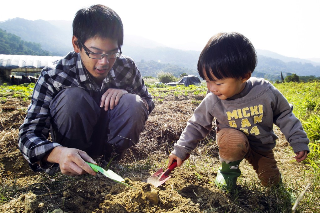 Farmer James Lam Chi-lap (left) teaches Javas Lo Ho-yin how to do some gardening at the farming collective Sangwoodgoon, Tse Uk Tsuen, Kam Sheung Road, Yuen Long. Photo: Dickson Lee