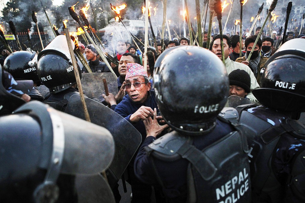 Nepalese police clash with demonstrators during a torch rally called by an opposition alliance of 30 parties in Kathmandu on Monday. Photo: AP
