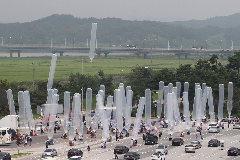 South Korean activists and North Korean defectors release balloons due to float north carrying sacks of propaganda leaflets in this file picture from July 2014. Photo: AP