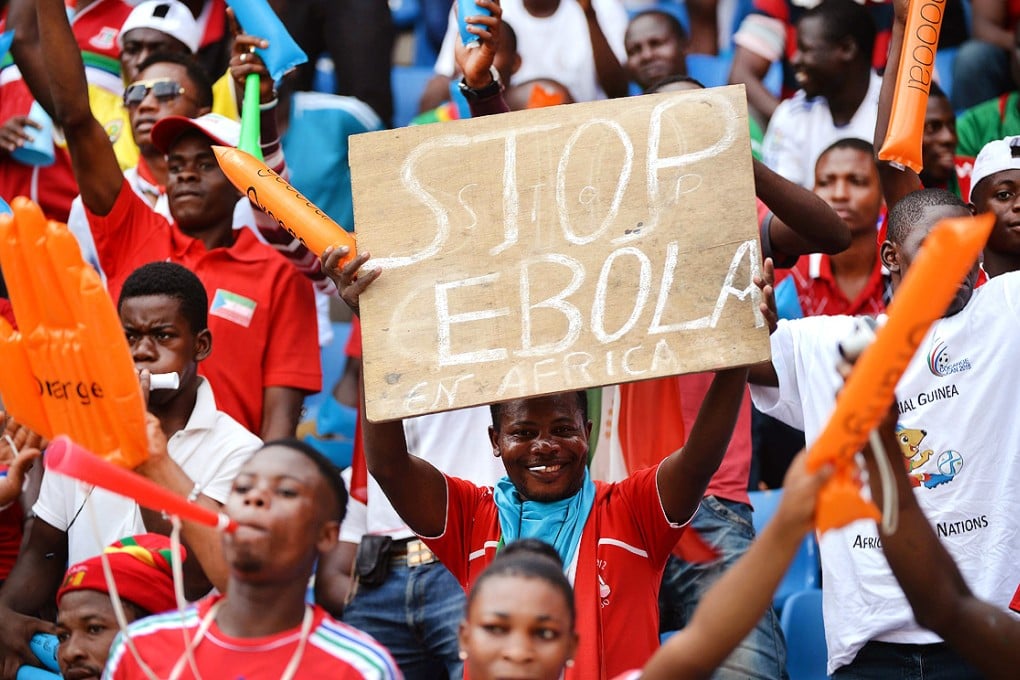 A football fan holds a placard reading 'Stop Ebola in Africa' ahead of the African Cup of Nations  match between hosts Equatorial Guinea and Congo at Bata Stadium on Saturday. Photo: AFP