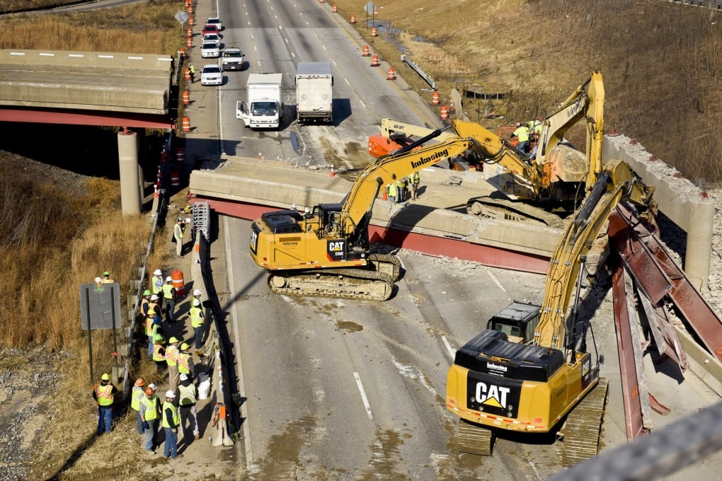 Work crews on Tuesday investigate the scene of a highway overpass collapse in Cincinnati that killed one person. Photo: AP