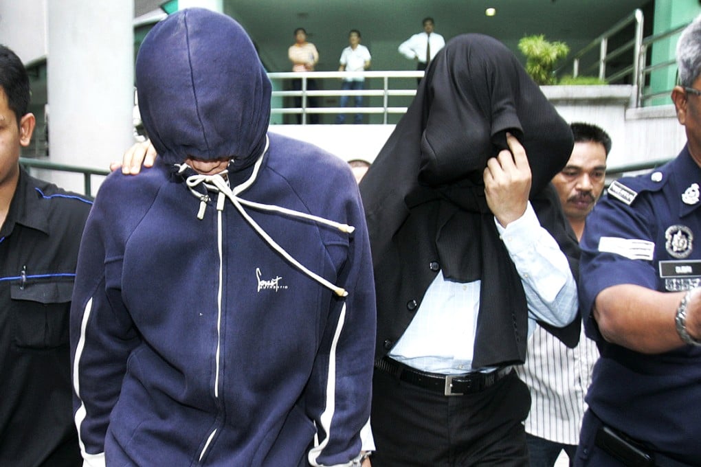 Policemen Sirul Azhar Umar and Azilah Hadri arrive at the courthouse in Shah Alam outside Kuala Lumpur in this January 2009 file picture. Photo: Reuters