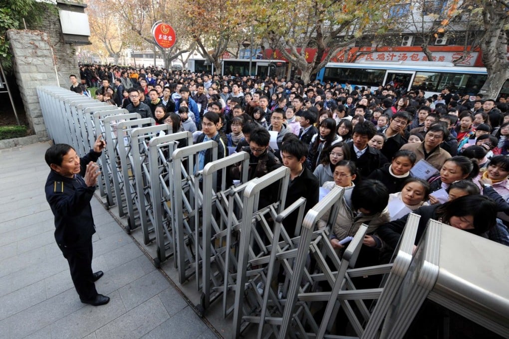 People wait to enter an examination hall for the annual national test to select public servants. Photo: Xinhua