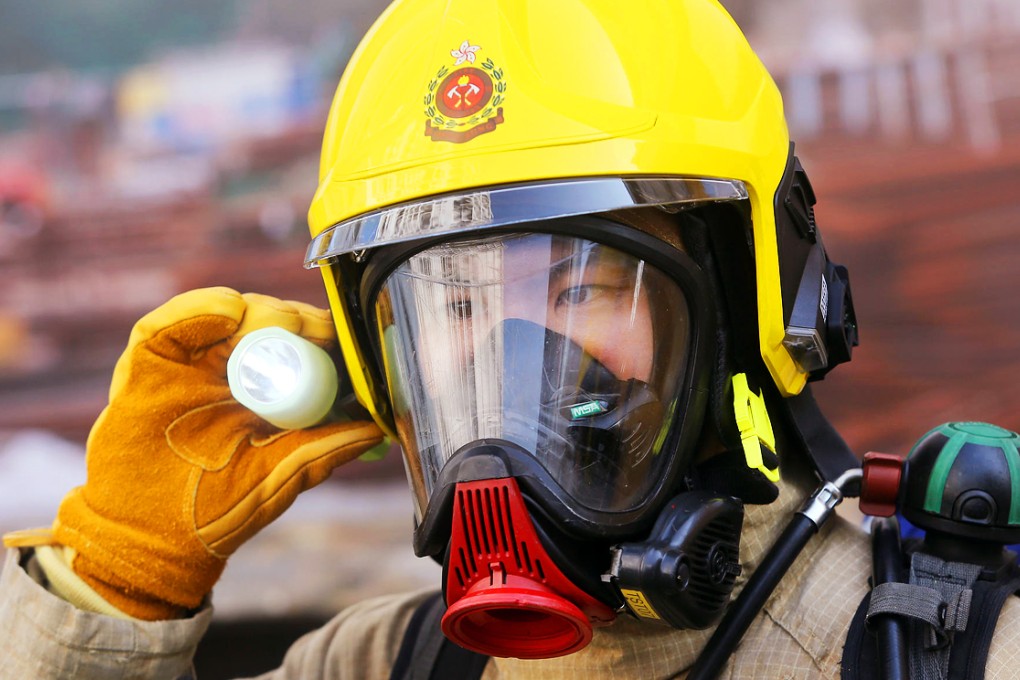A fireman demonstrates the new functions of the recently acquired helmets yesterday. Photo: Sam Tsang