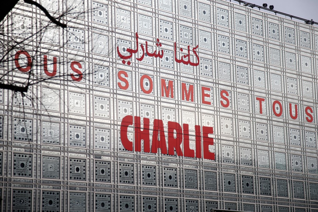 The Arab Institute building in Paris bears the message 'We are all Charlie', to pay tribute to the journalists and police who were killed in an attack January 7, 2015. Photo: Reuters