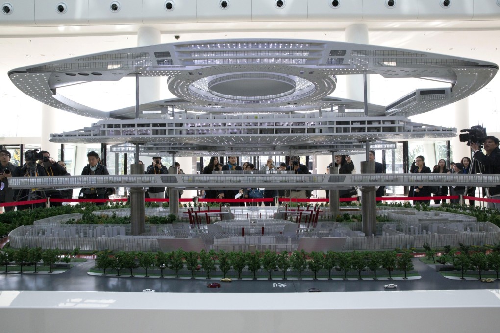 Visitors look at a scale model of BAIC Motors research and development centre in Beijing. The company said sales of its branded cars rose in 2014. Photo: AP