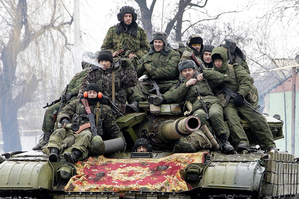 Members of the armed forces of the separatist self-proclaimed Donetsk People's Republic drive a tank on the outskirts of Donetsk. Photo: Reuters
