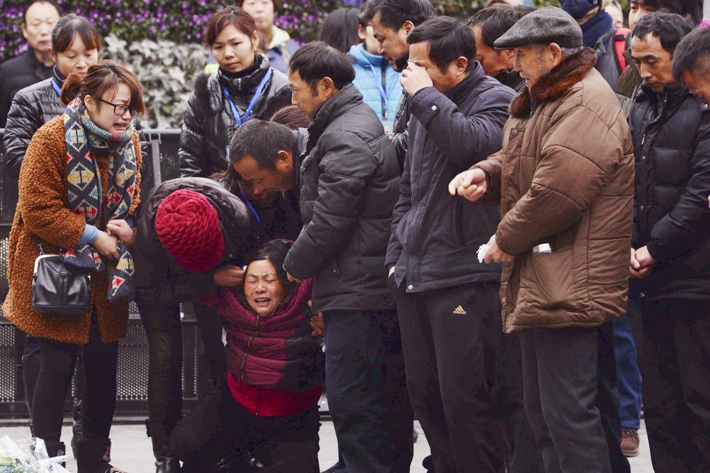 A woman (third left) grieves as she is comforted by other relatives of a New Year's Eve stampede victim. Photo: AP