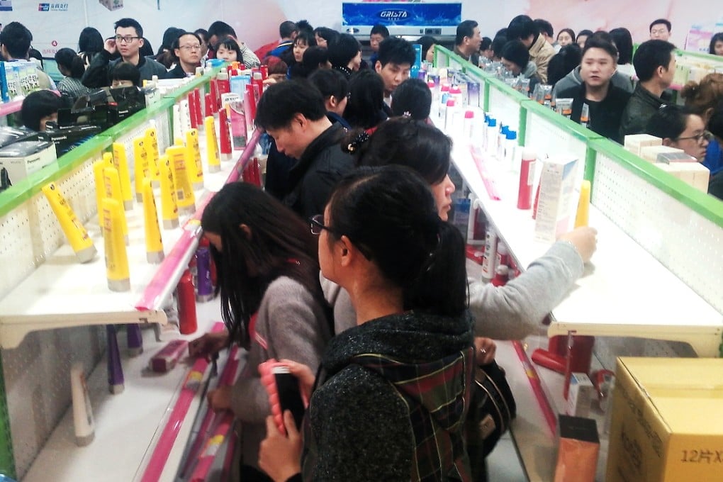 Chinese shoppers empty the shelves at Guangzhou's first duty-free store on its opening day on Friday. Photo: Mimi Lau