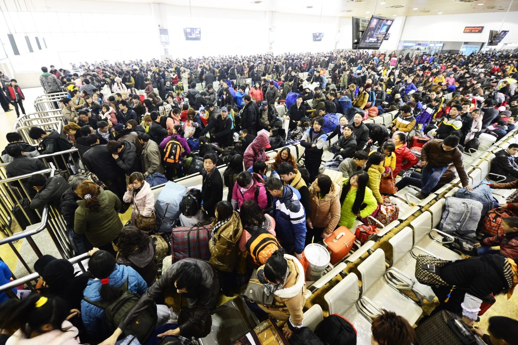 Chinese passengers wait in line to get on a train in Hangzhou, Zhejiang province, during the Lunar New Year peak travel season in 2013. Photo: Xinhua