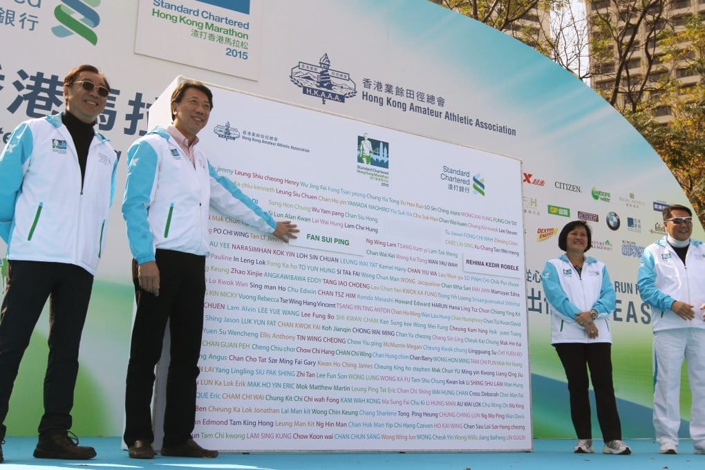 Benjamin Hung Pi-cheng, Standard Chartered Bank chief executive, joins other members of the organising committee at the opening ceremony for the 2015 edition of the Standard Chartered Hong Kong Marathon. Photo: SCMP Pictures