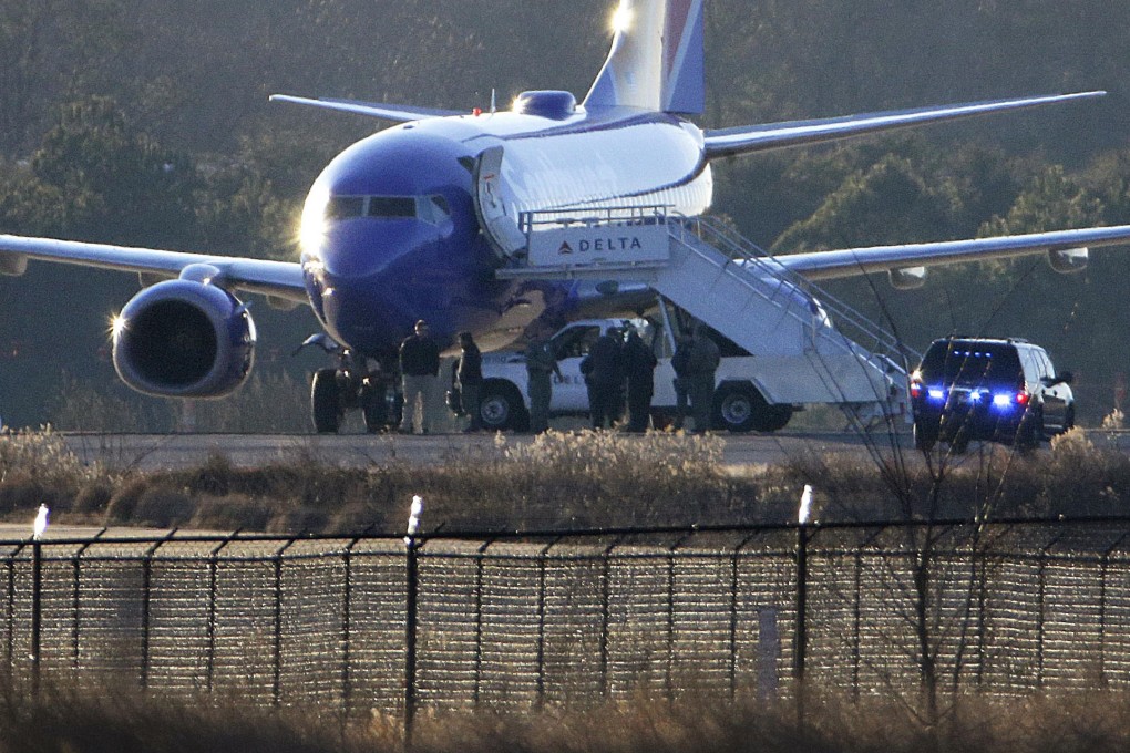 Law enforcement officials stand by plane in Atlanta. Photo: AP