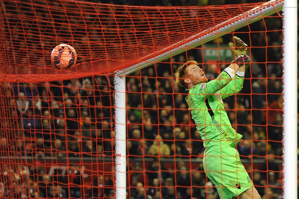 Bolton Wanderers goalkeeper Adam Bogdan watches a shot from Liverpool's Philippe Coutinho go over the bar during their goalless draw. Photo: EPA