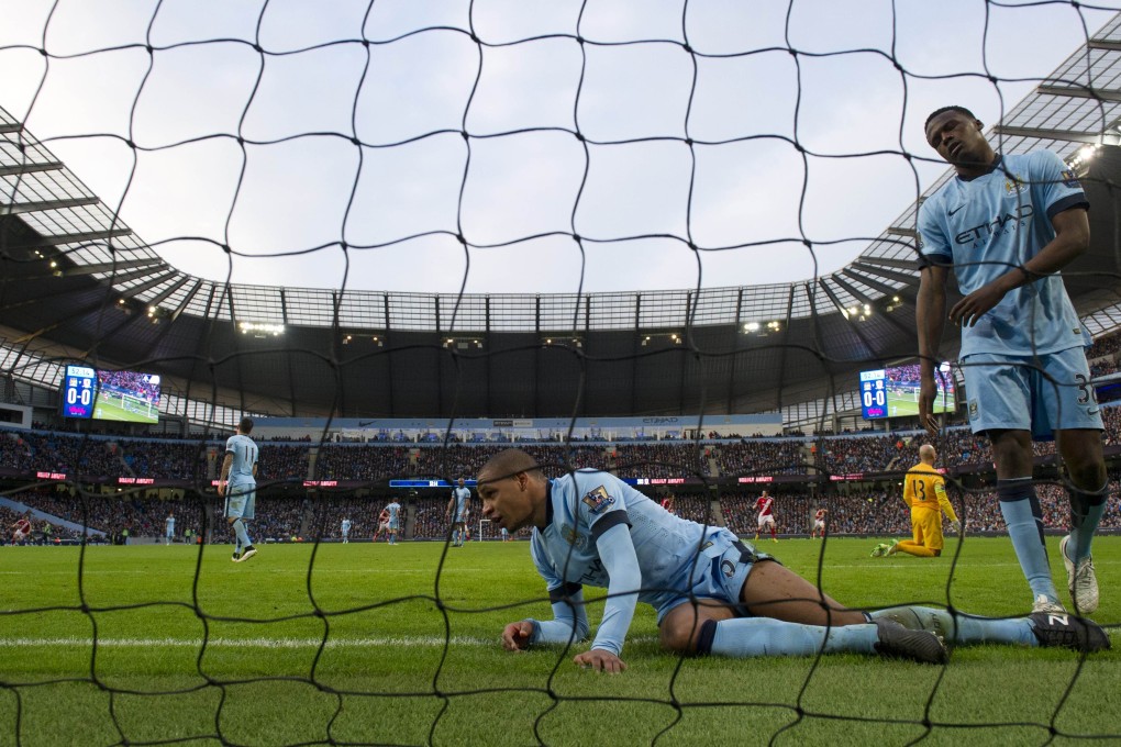 Down and out: Manchester City's Fernando and Dedryck Boyata are powerless to stop Middlesbrough's first goal, scored by Patrick Bamford. Photo: AFP