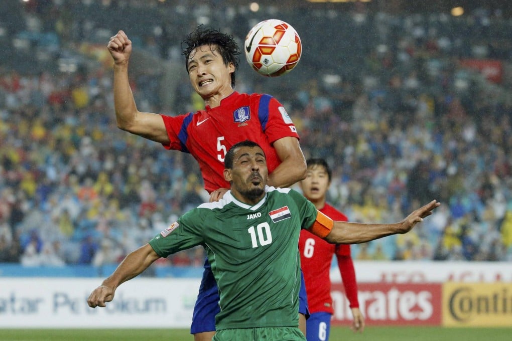South Korea's Kwak Tae-hwi leaps high above Iraq's Younis Mahmoud to head the ball in their Asian Cup semi-final in Sydney. South Korea won 2-0. Photo: Reuters