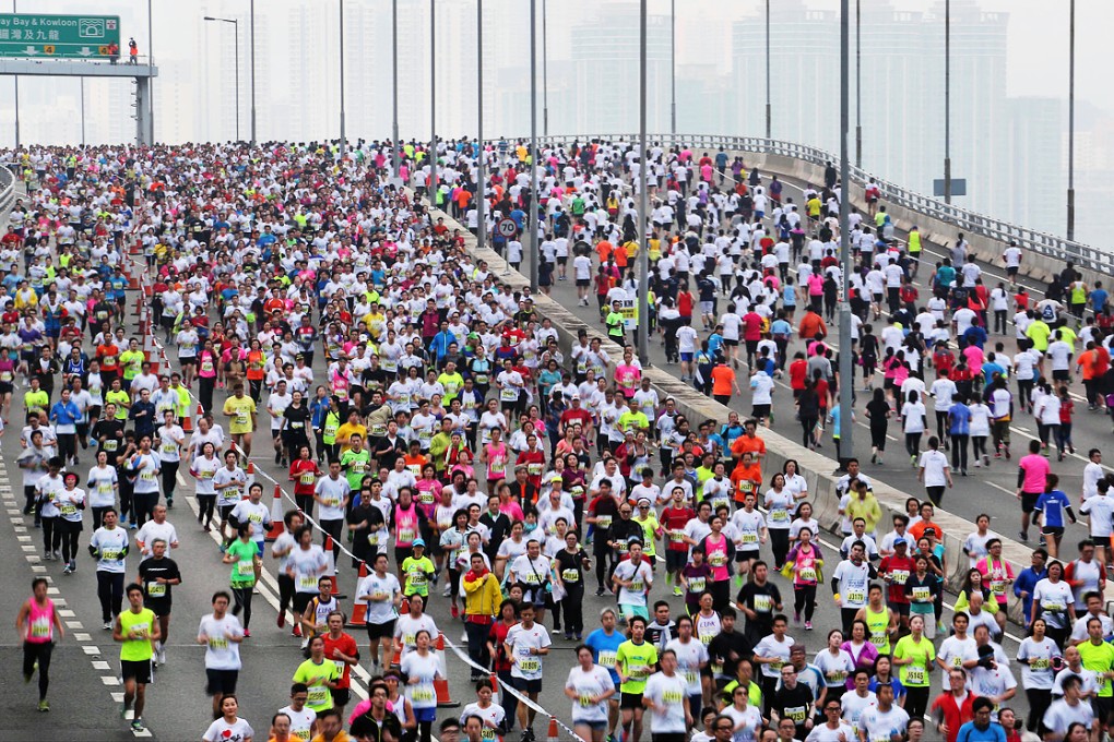 Participants pack the Island Eastern Corridor during yesterday's race. There were 73,000 entrants. Photo: Felix Wong