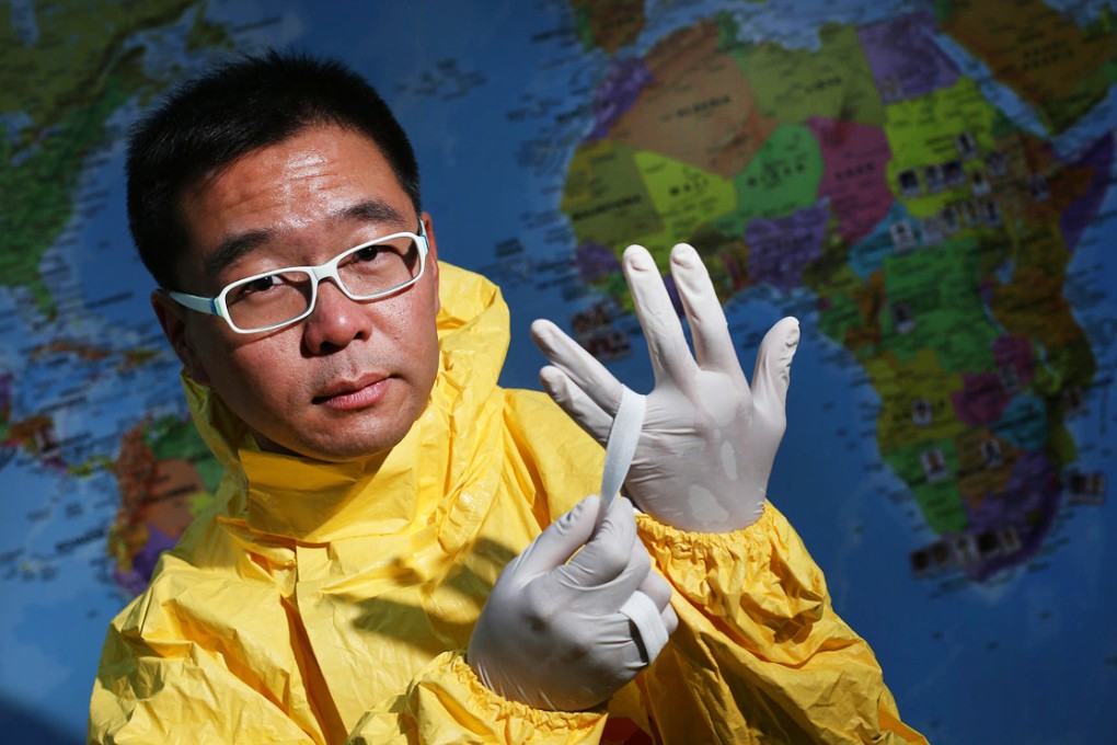 At Medecins Sans Frontieres' office in Kennedy Town, Chiu Cheuk-pong shows the kind of protective gear he wore in Liberia. Photo: Nora Tam