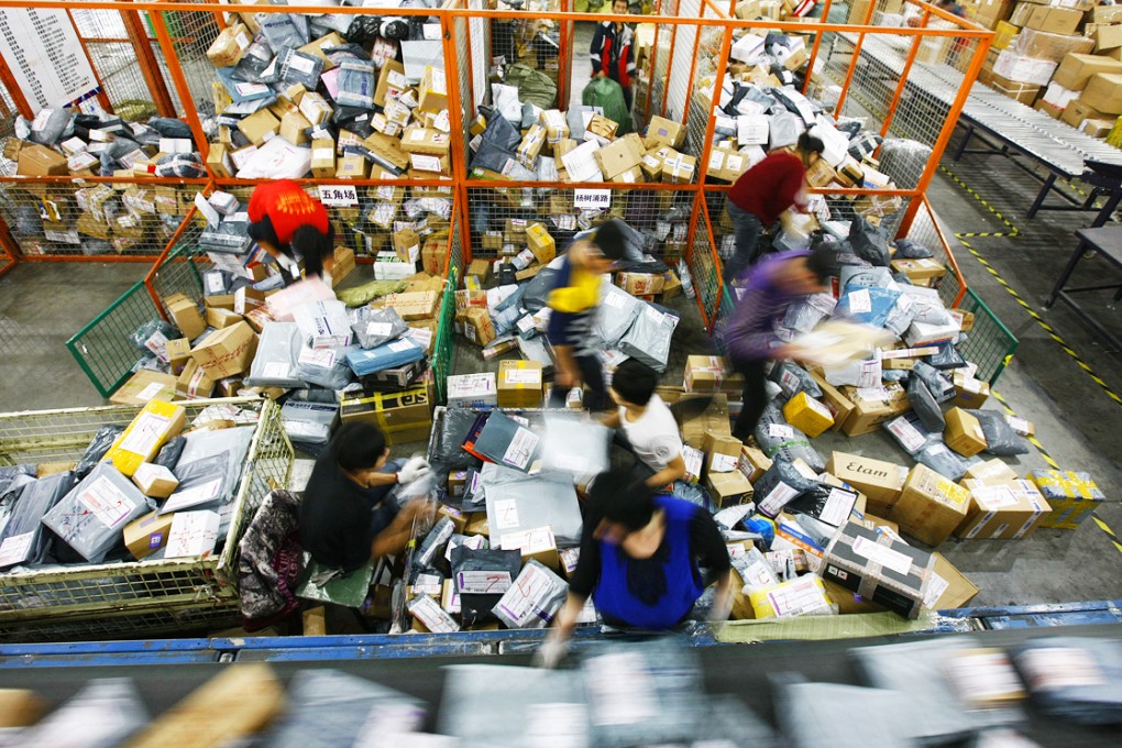 Workers sort parcels for delivery at a distribution centre in Shanghai. Photo: Xinhua