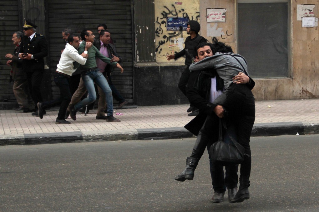 Egyptian Shaima al-Sabbagh (right) is carried away to safety by a fellow protester after she was injured during clashes with police. Photo: AFP