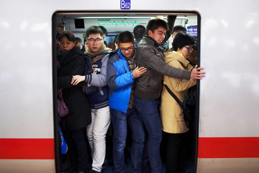 Beijing commuters crowd into a train on their daily journey to work, which takes an average of 52 minutes. Photo: Xinhua