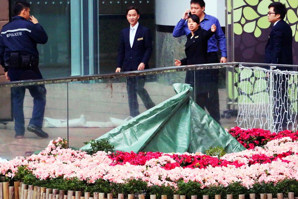 Police cover the body as people arrive for work. Photo: Felix Wong