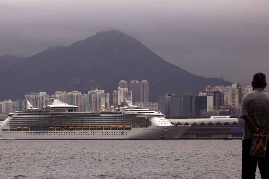 A man looks at a cruise ship docked in Hong Kong. Carnival and China Merchants Bank have signed agreements for two possible joint ventures. Photo: Reuters