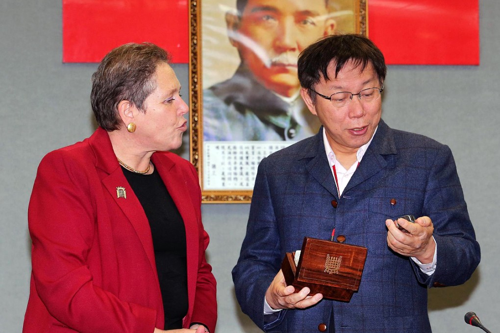 Taipei Mayor Ko Wen-je (right) receives a gift of a watch from British transport minister Baroness Susan Kramer. Photo: AFP