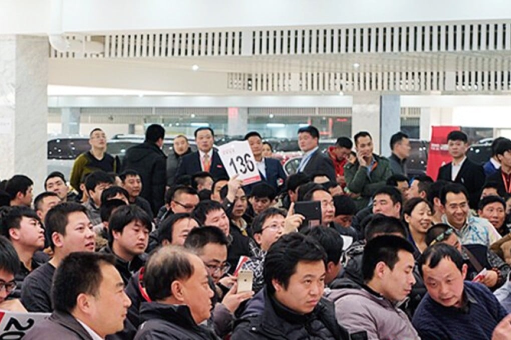 Chinese people place their bids for cars that used to belong to the central government during an auction this week. Photo: SCMP Pictures