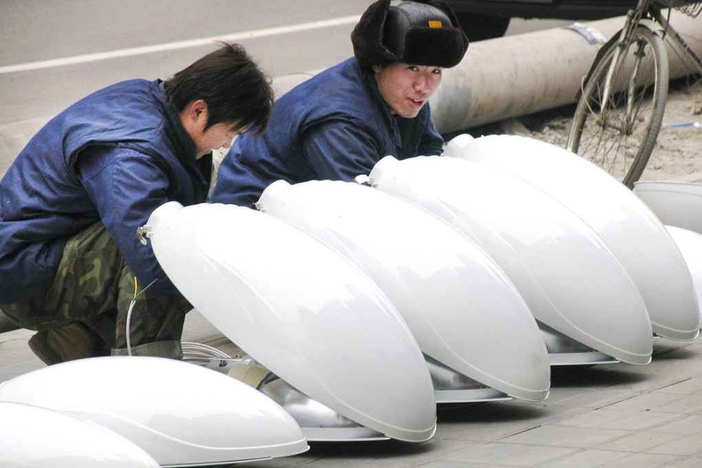 Workers assemble street lights in China. The street lighting industry involves enormous amounts of bribes, insiders say. Photo: EPA