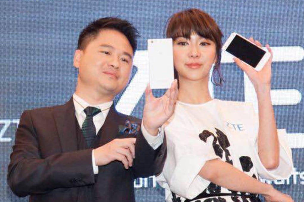 Adam Zeng with singer Fiona Sit at the launch of the new smartphone. Photo: SCMP Pictures