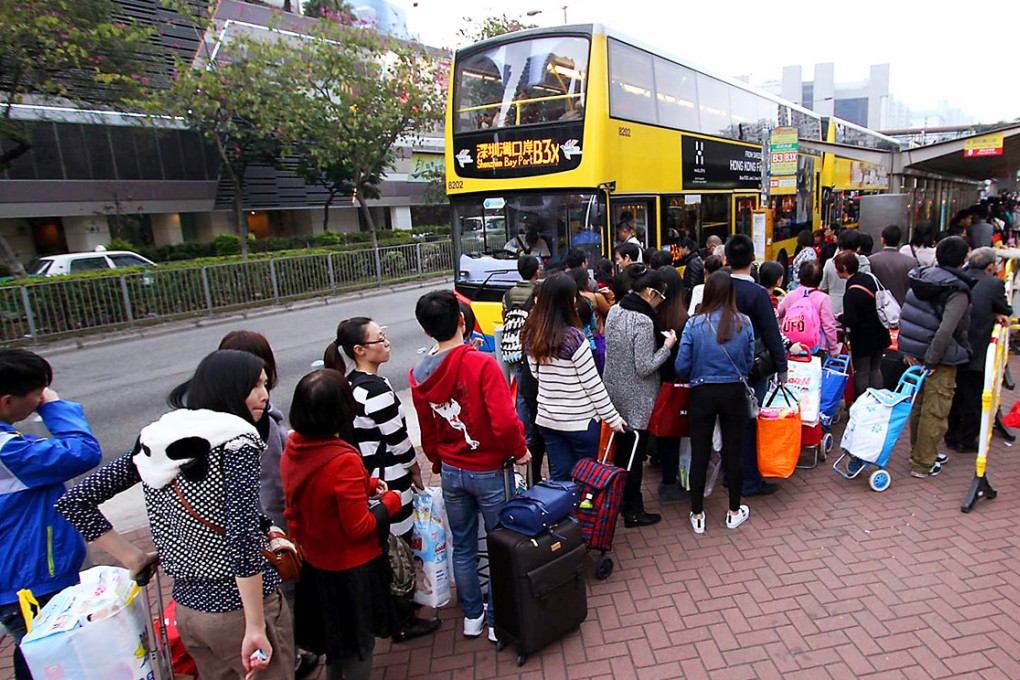 Cross-border shoppers form a lengthy queue at the Tuen Mun bus terminal. Photo: SCMP Pictures