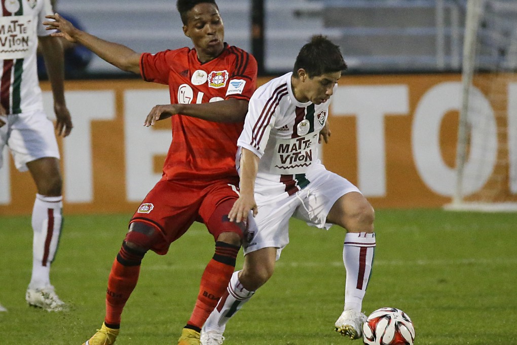 Bayer Leverkusen's Wendell (left) makes a move to get position on Fluminense's Dario Conca. Photo: AP