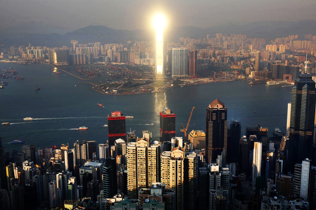 The city's tallest building, the International Commerce Centre on Austin Road West, is a striking beacon of light at sunset. Photo: Robert Ng