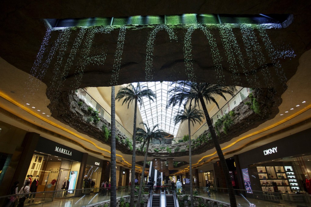 A waterfall awaits shoppers at a resort operated by Sands China in Macau. The firm announced the launch of The Parisian in the territory has been delayed to 2016. Photo: Bloomberg