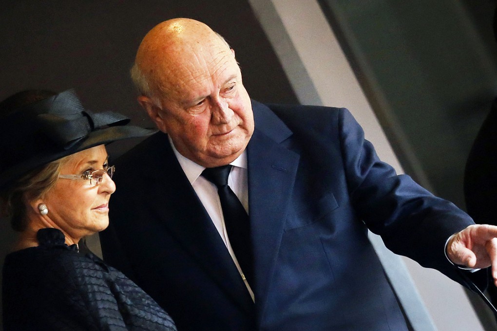 Former South African president FW De Klerk gestures as he arrives with his wife Elita for the memorial service for former South African president Nelson Mandela at the FNB Stadium in Soweto, near Johannesburg on December 10, 2013. Photo: AP