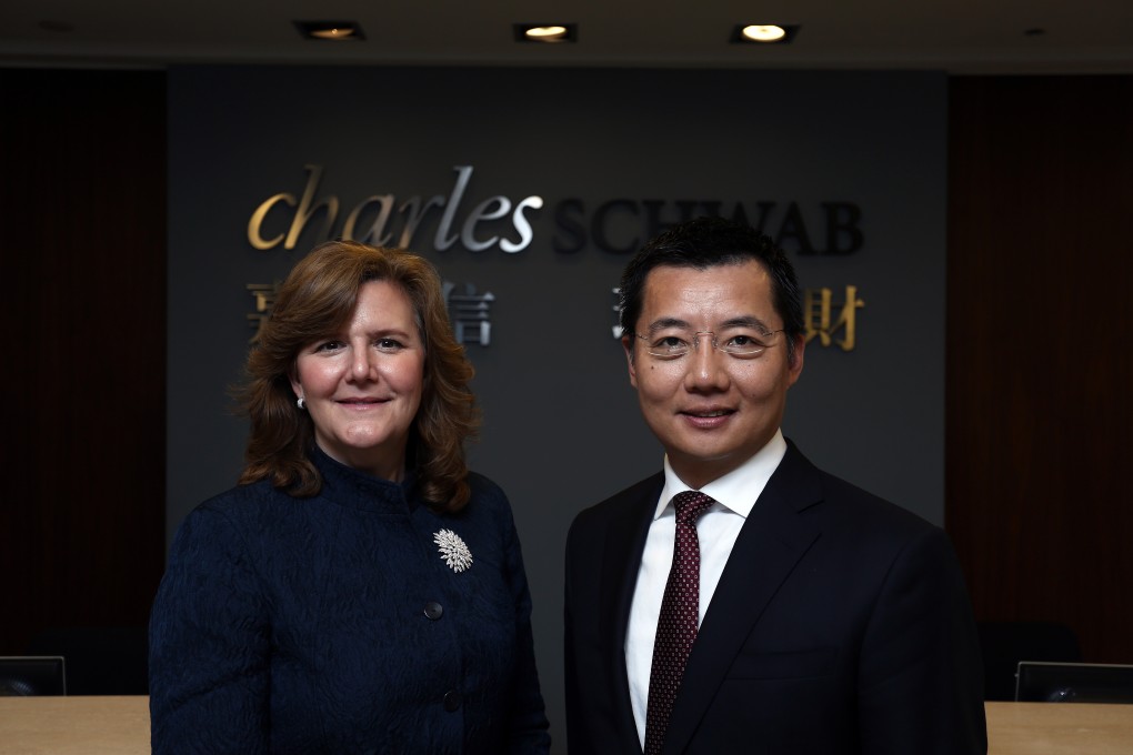 Lisa Hunt, executive vice president at Charles Schwab's International Services & Special Business Development, and James Sun, managing director at Charles Schwab Hong Kong, pose for a picture in the firm's Hong Kong office. Photo: Jonathan Wong