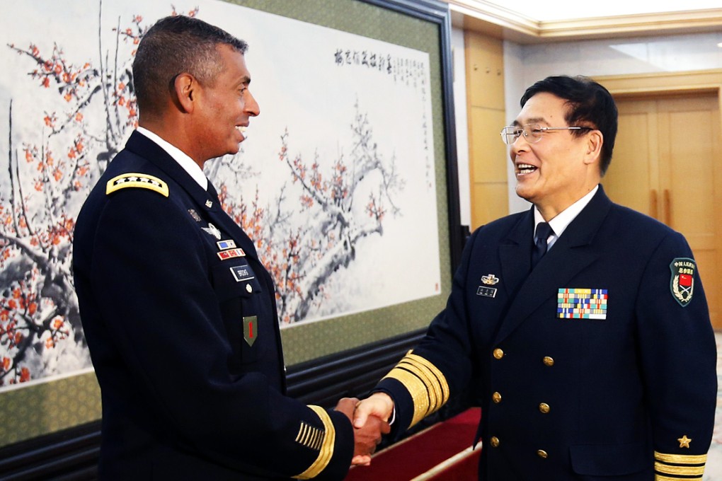 Sun Jianguo, Deputy Chief of General Staff of the PLA, right, greets Vincent Brooks, Commanding General of the US Army Pacific, in Beijing on January 15. Photo: AFP