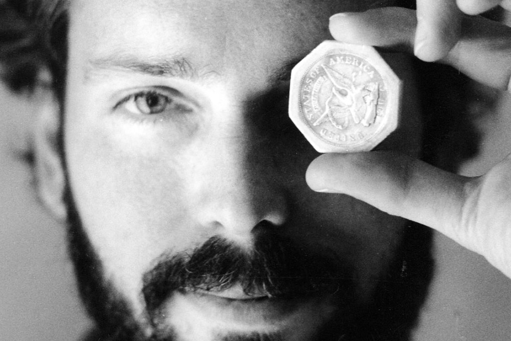 Tommy Thompson holds a US$50 pioneer gold piece retrieved earlier in 1989 from the wreck of the gold ship Central America. Photo: AP