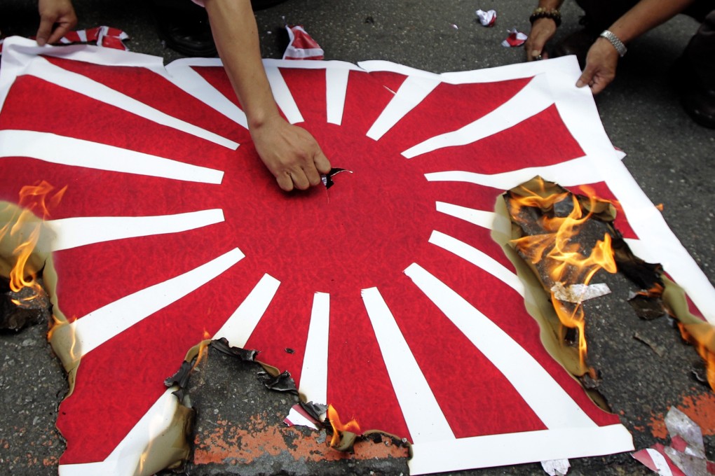 Activists burn a Japanese flag during a protest in front of the Japan Interchange Association, the de facto Japanese embassy, in Taipei. Photo: Reuters