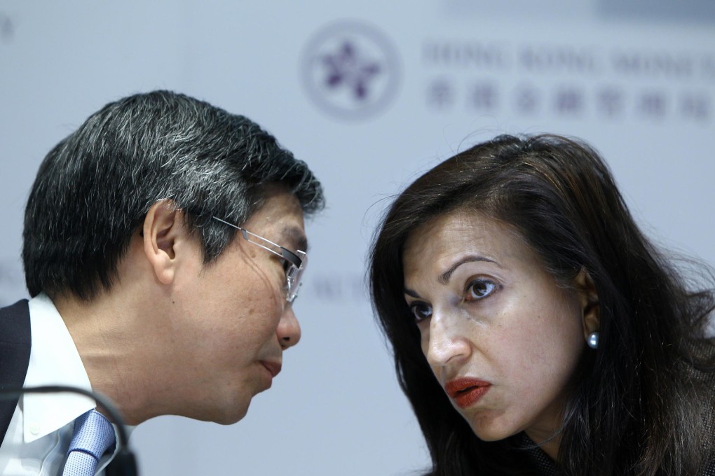 Meena Datwani, the director-general of the Hong Kong Monetary Authority's enforcement division, talks to deputy chief executive Arthur Yuen. Photo: Jonathan Wong