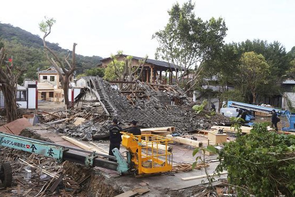Police inspect the demolished film set after a construction worker was killed when scaffolding around a building being demolished suddenly collapsed. Photo: AP