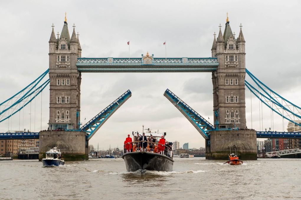 The Havengore, the boat that carried Churchill's coffin in 1965, sails underneath London's Tower Bridge yesterday in a re-enactment of his funeral procession. Photo: AFP