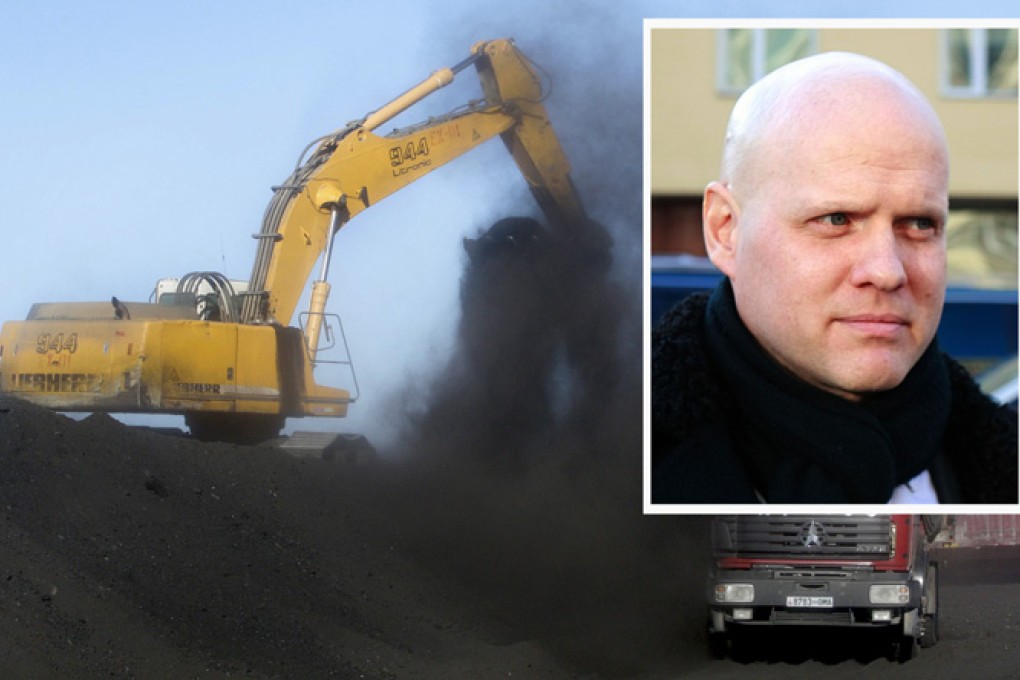 Justin Kapla (inset) was one of the SouthGobi executives found guilty of tax crimes in Mongolia. In this file photo, coal is loaded onto SouthGobi Energy trucks. Photo: Bloomberg, AFP